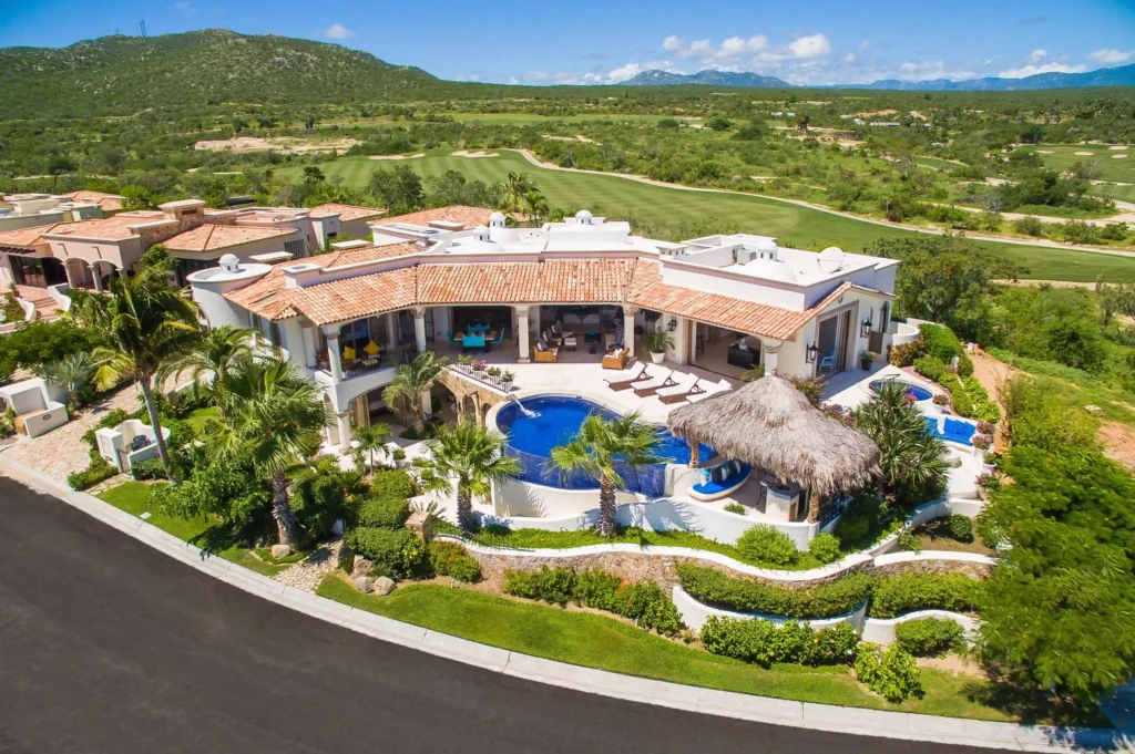 Modern Homes in Cove Club for Sale featuring contemporary oceanfront estate with glass architecture and private club setting